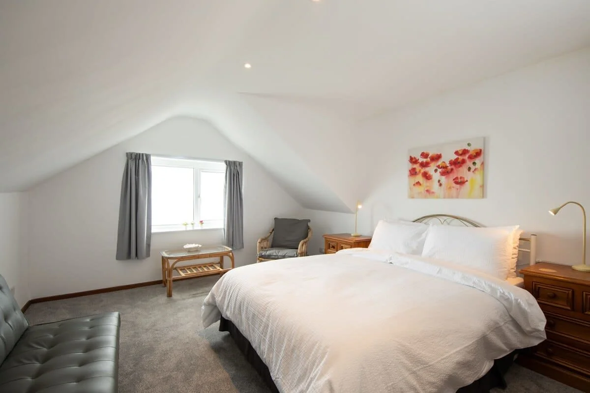 The gorgeous loft style master bedroom with a luxuriously large king bed