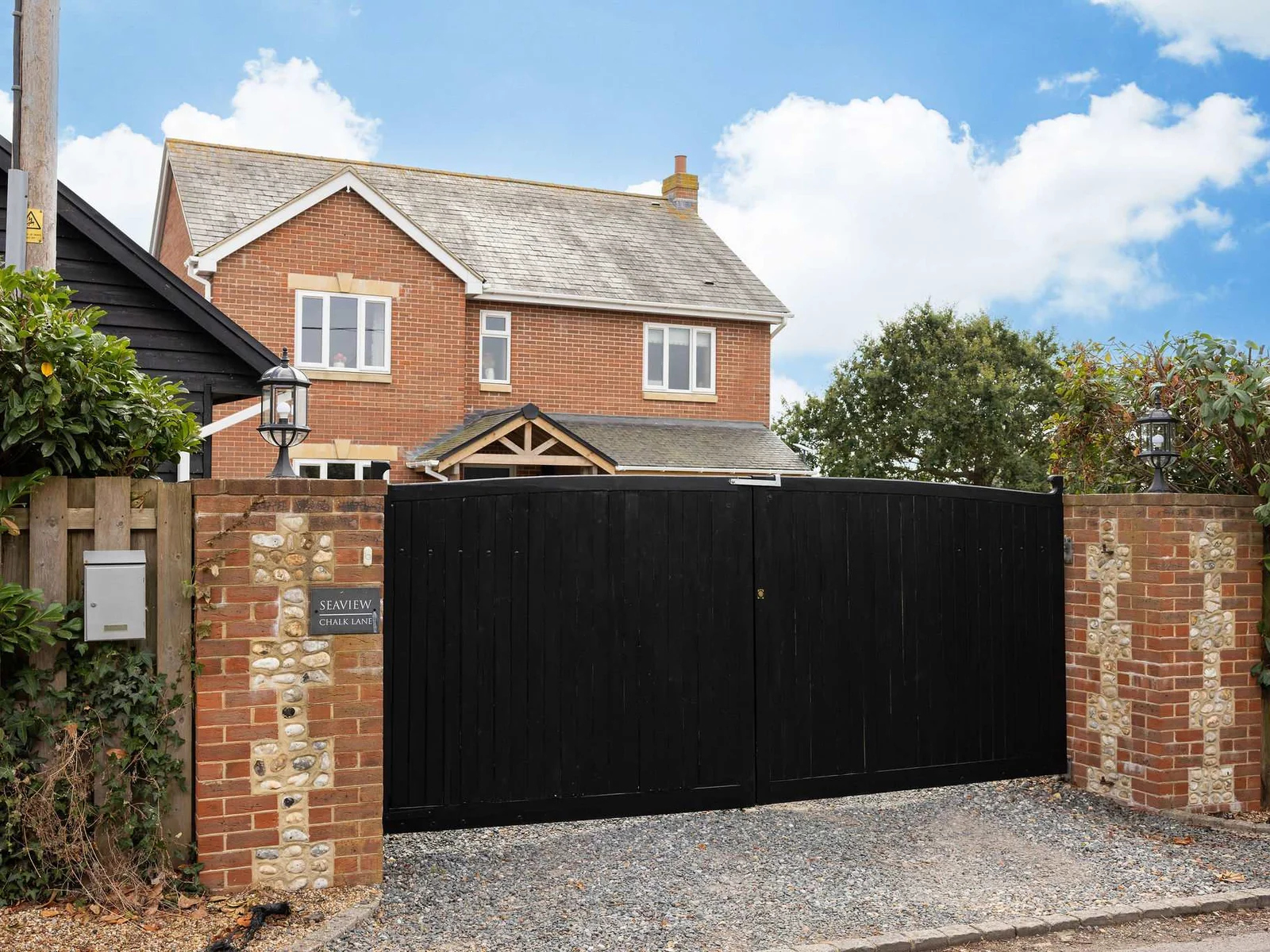 A private gated entrance and generous driveway welcome you to the property, giving a real sense of space and seclusion from the moment you arrive.