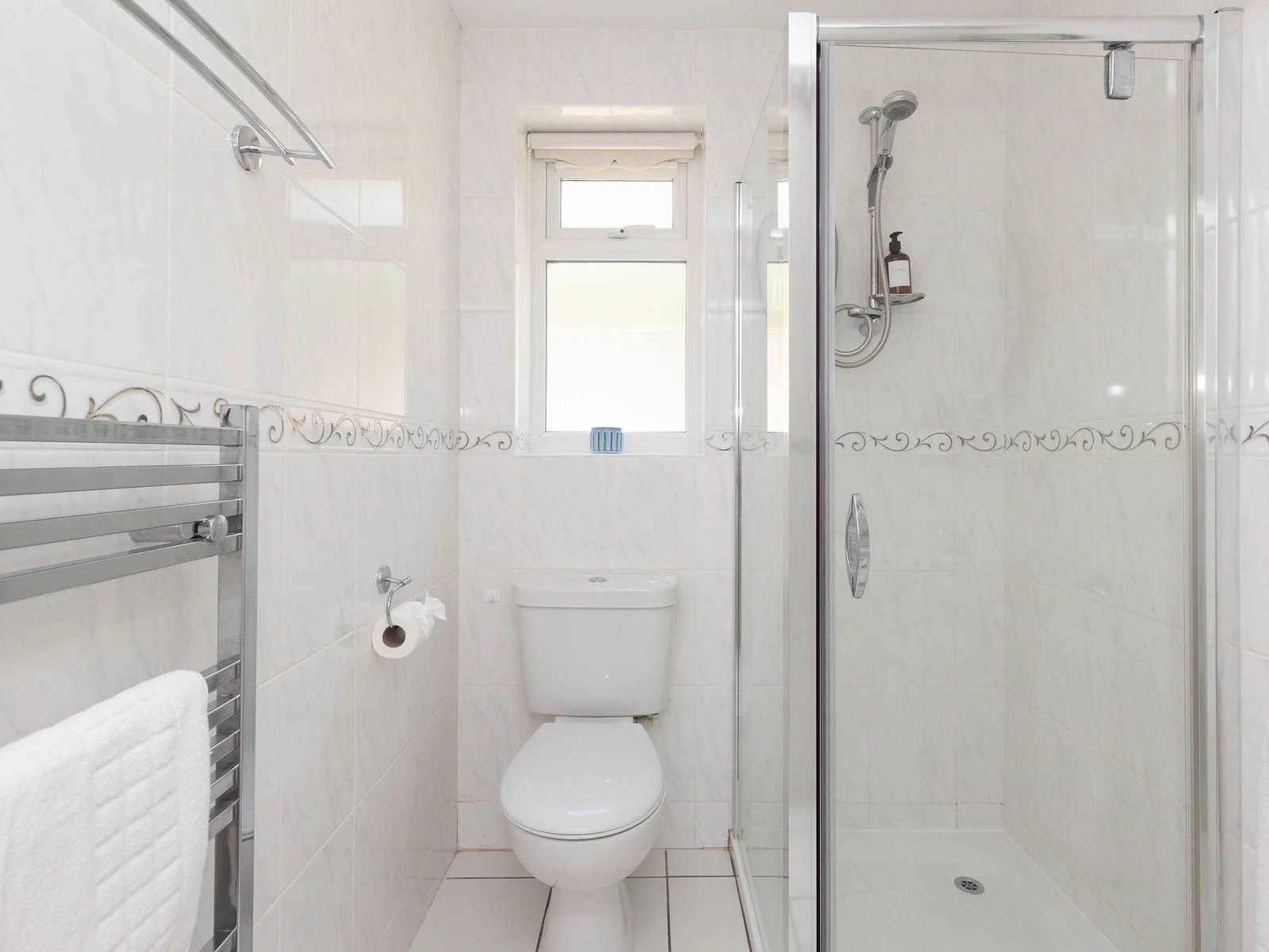 Bright en-suite with walk-in shower and classic tiling