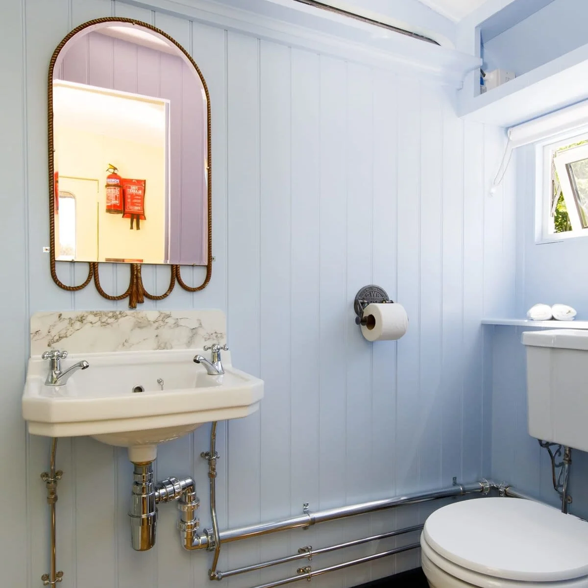 The powder blue shower room has vintage fixtures and fitting to continue the theme.