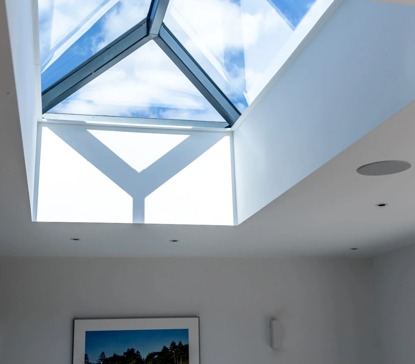Large skylight fills the space with natural light, creating a bright and airy atmosphere.