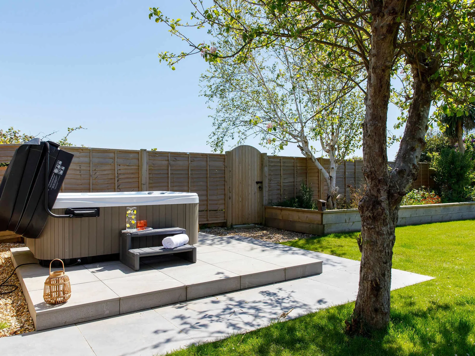 A spacious garden perfect for outdoor activities and relaxation, featuring a hot tub for unwinding.