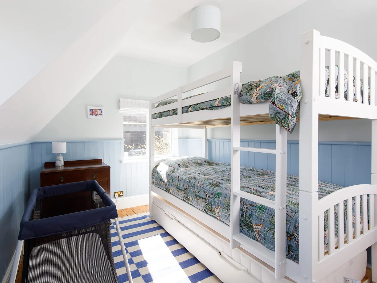 The bunk room is great for siblings. It also has a trundle bed to sleep a total of three children. The home has a travel cot and high chair, as well as stair gate.
