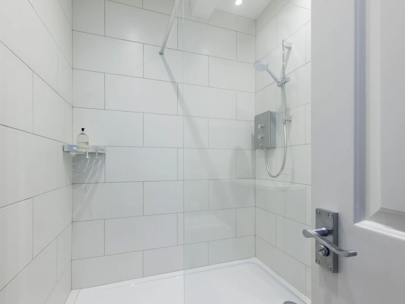 The bathroom has a large walk in shower, WC and sink.