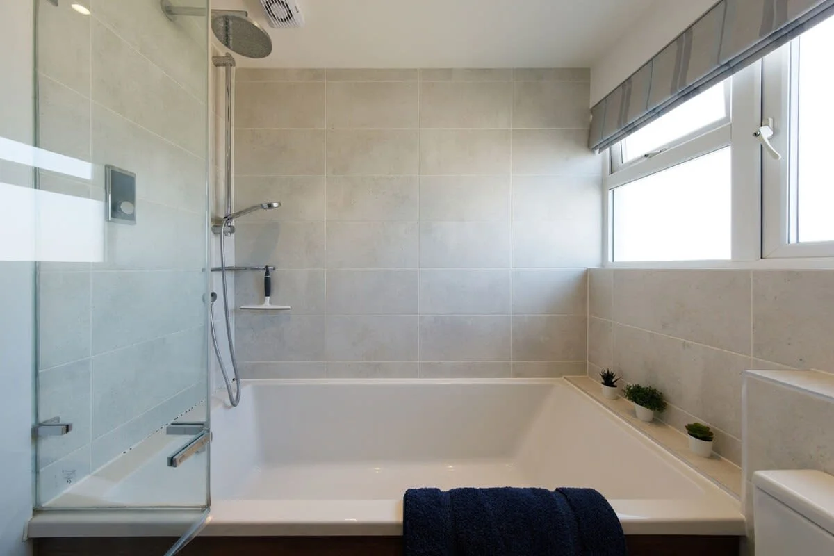 The bath has an overhead shower.