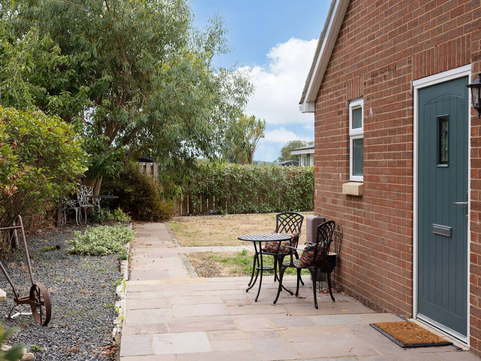 A charming little outdoor seating spot tucked beside the house — perfect for a quiet morning coffee or a peaceful moment in the fresh country air.