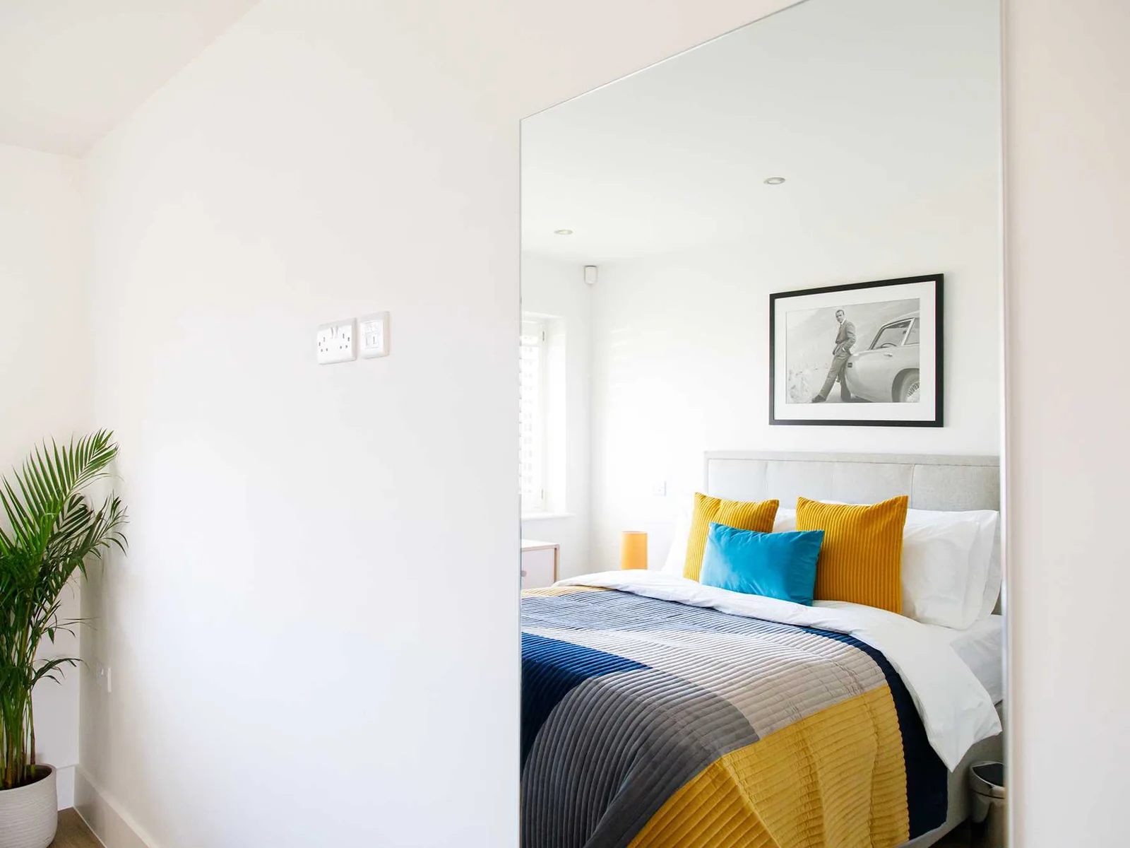 The ground floor king bedroom is beautifully decorated with pops of colour.