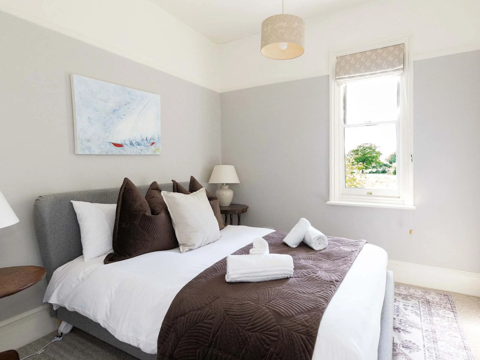 Comfortable double bedroom with soft neutral styling.