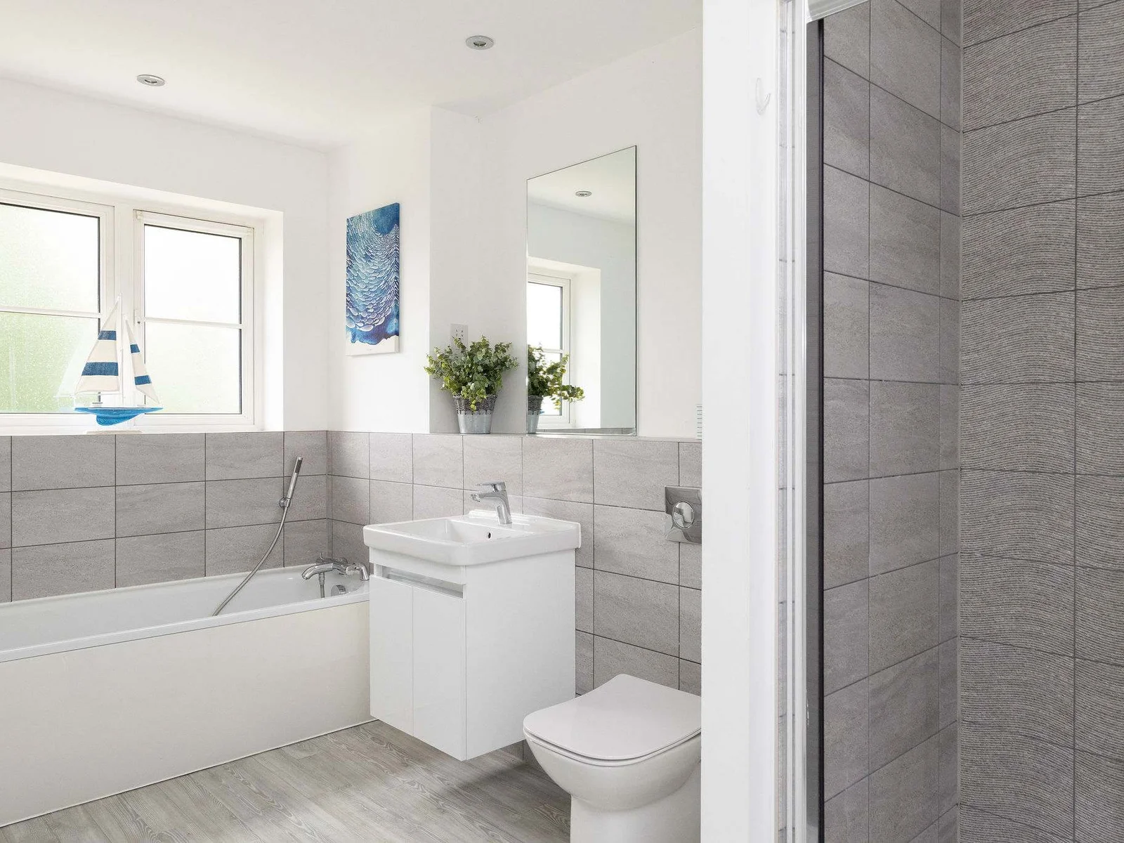 The modern bathroom, conveniently equipped with both a full-size bath and a separate walk-in shower.