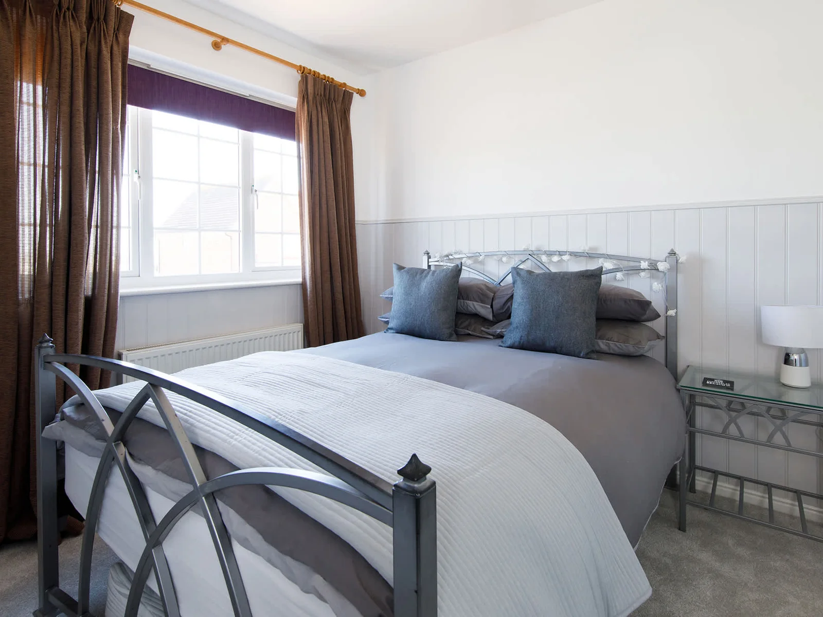 The second double room is beautifully furnished in sofa greys.