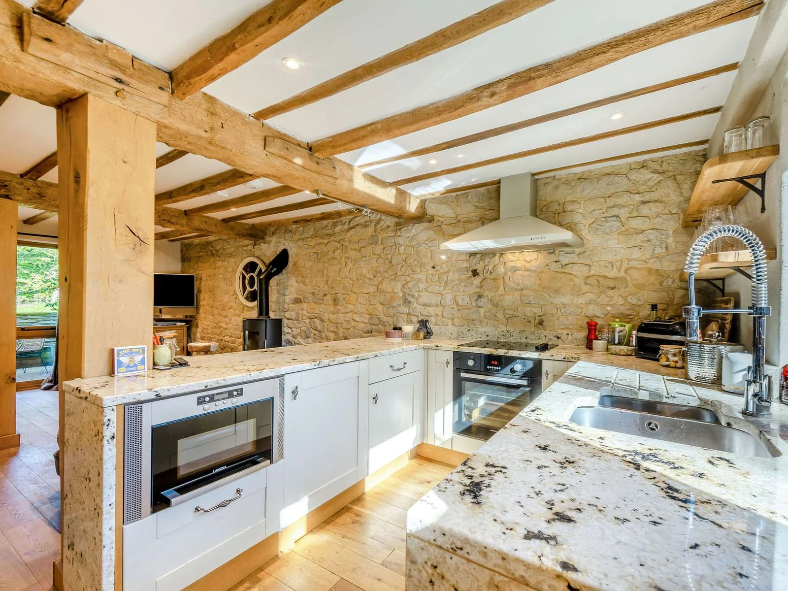 The Hay Barn’s characterful kitchen, with exposed stone, oak beams and granite worktops