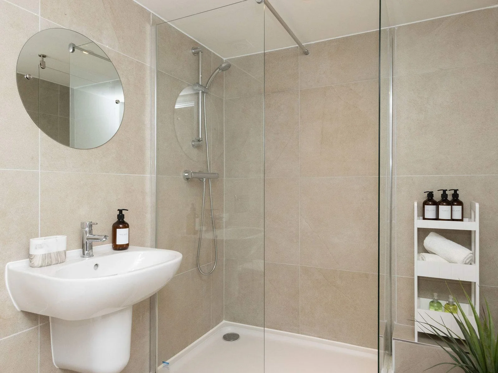 Contemporary walk-in shower room with modern finishes, fresh towels and thoughtful holiday essentials.