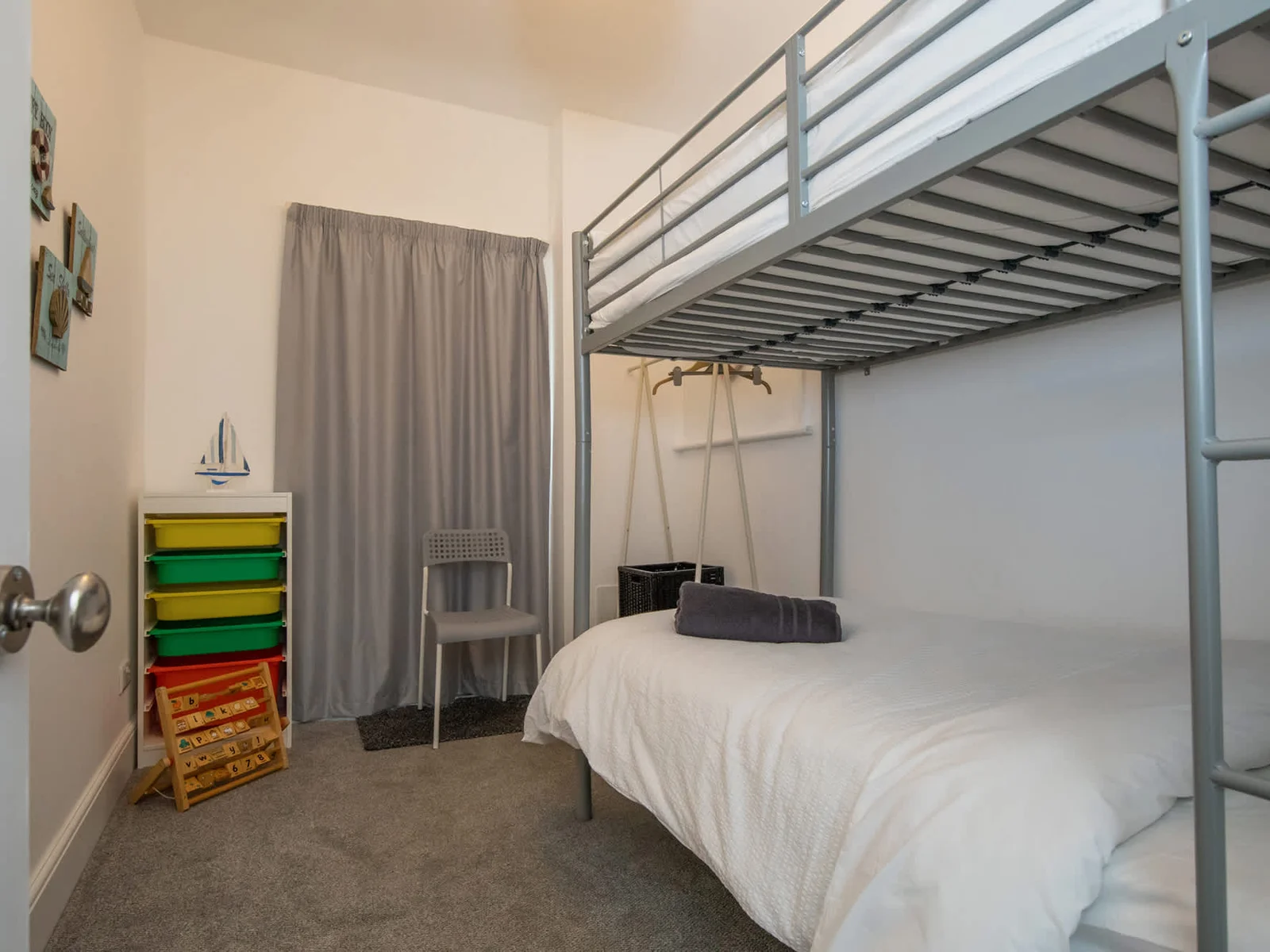 The fun kids room with a bunk bed and games
