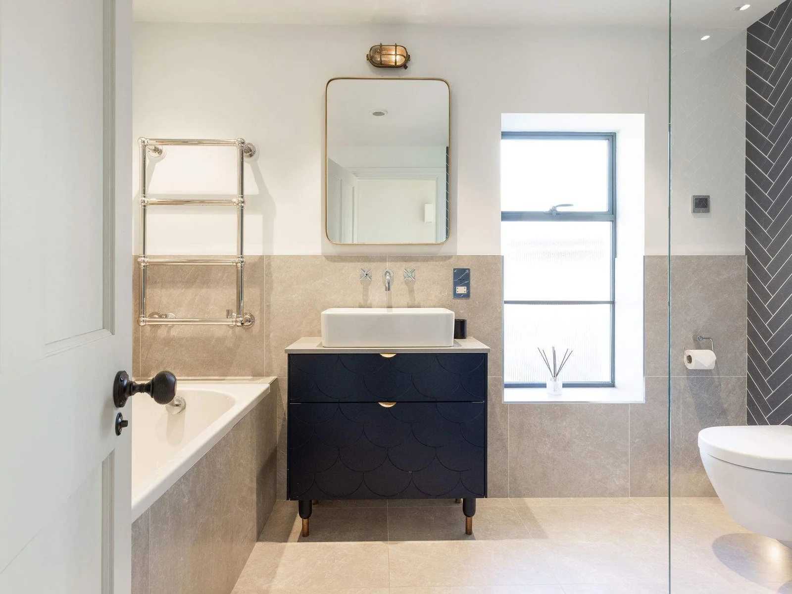Spacious family bathroom with bath, walk-in shower, and stylish contemporary fittings throughout.