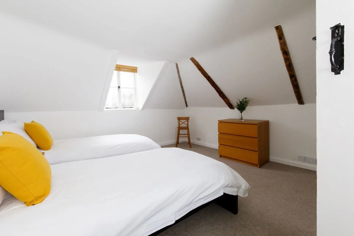On the second floor are two twin bedrooms, both with comfy beds, drawers and side tables.