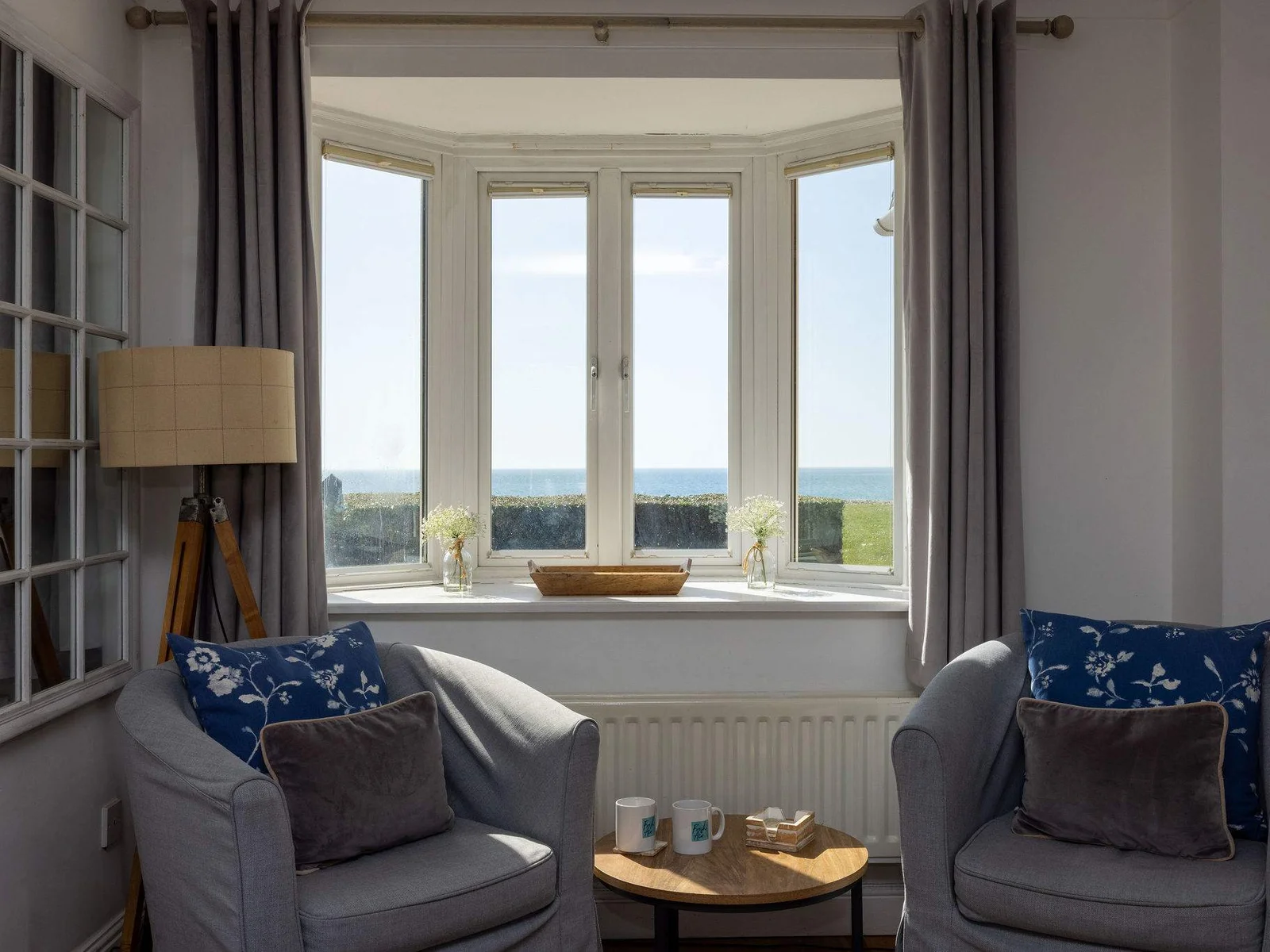 Relax with uninterrupted sea views from this peaceful coastal sitting area filled with natural light.