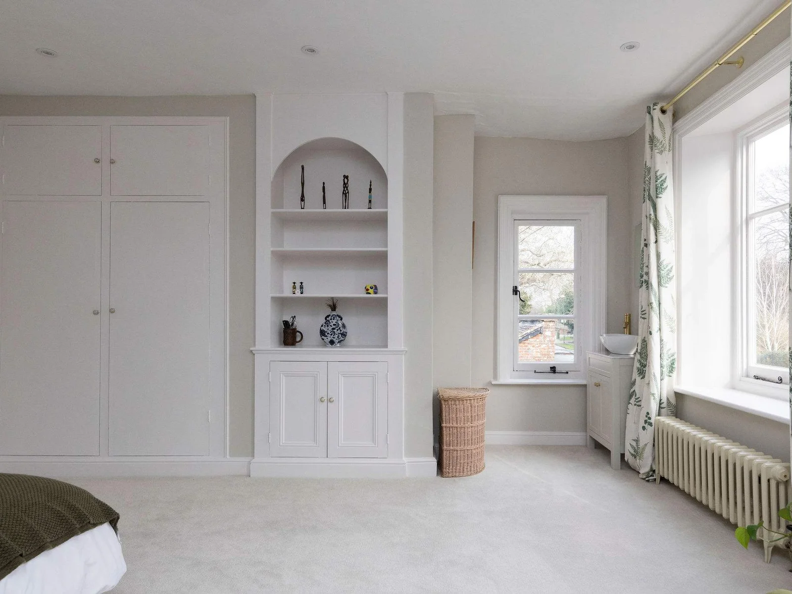 Spacious second bedroom with built-in storage and bright windows