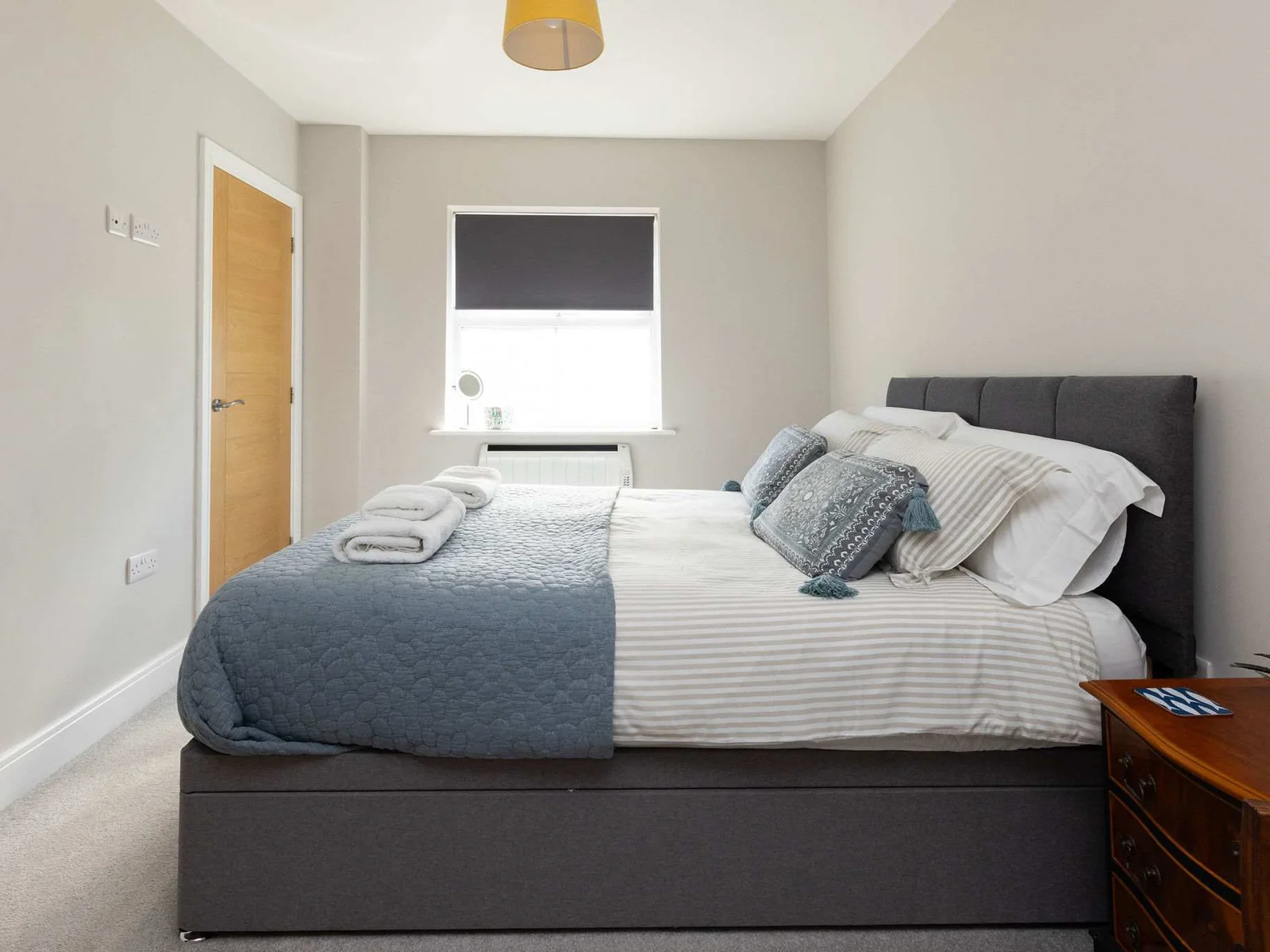 Bright king bedroom with comfortable furnishings, perfect for a peaceful seaside holiday retreat