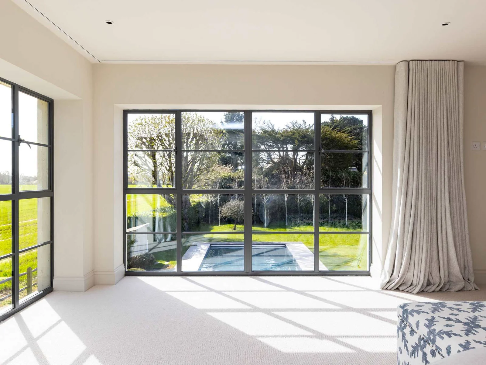 Wake up to stunning views of the heated pool and lush gardens from your bedroom.
