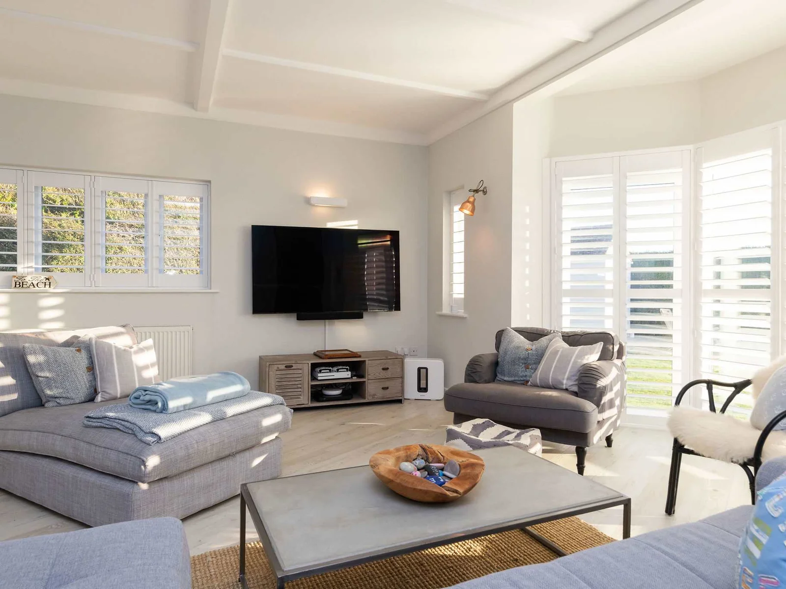 Bright & airy living room with bay windows.