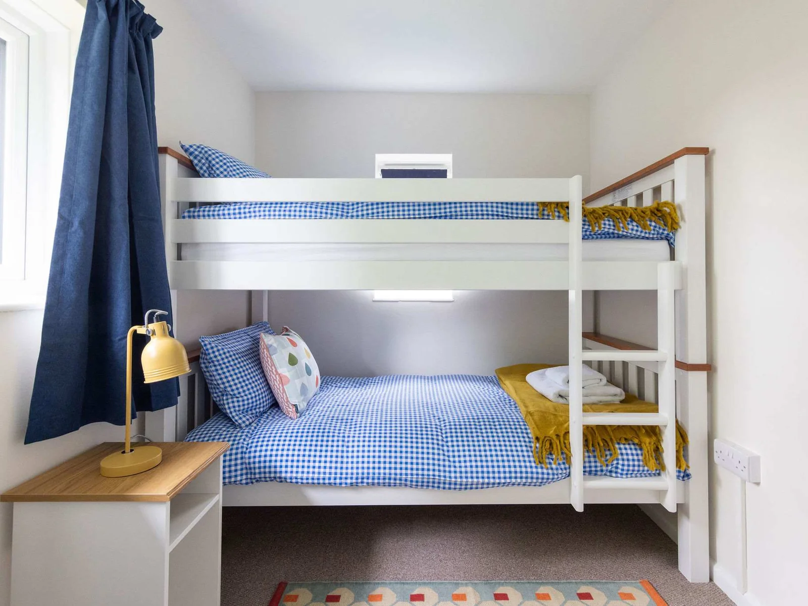 Single bunk beds with blue gingham linen!