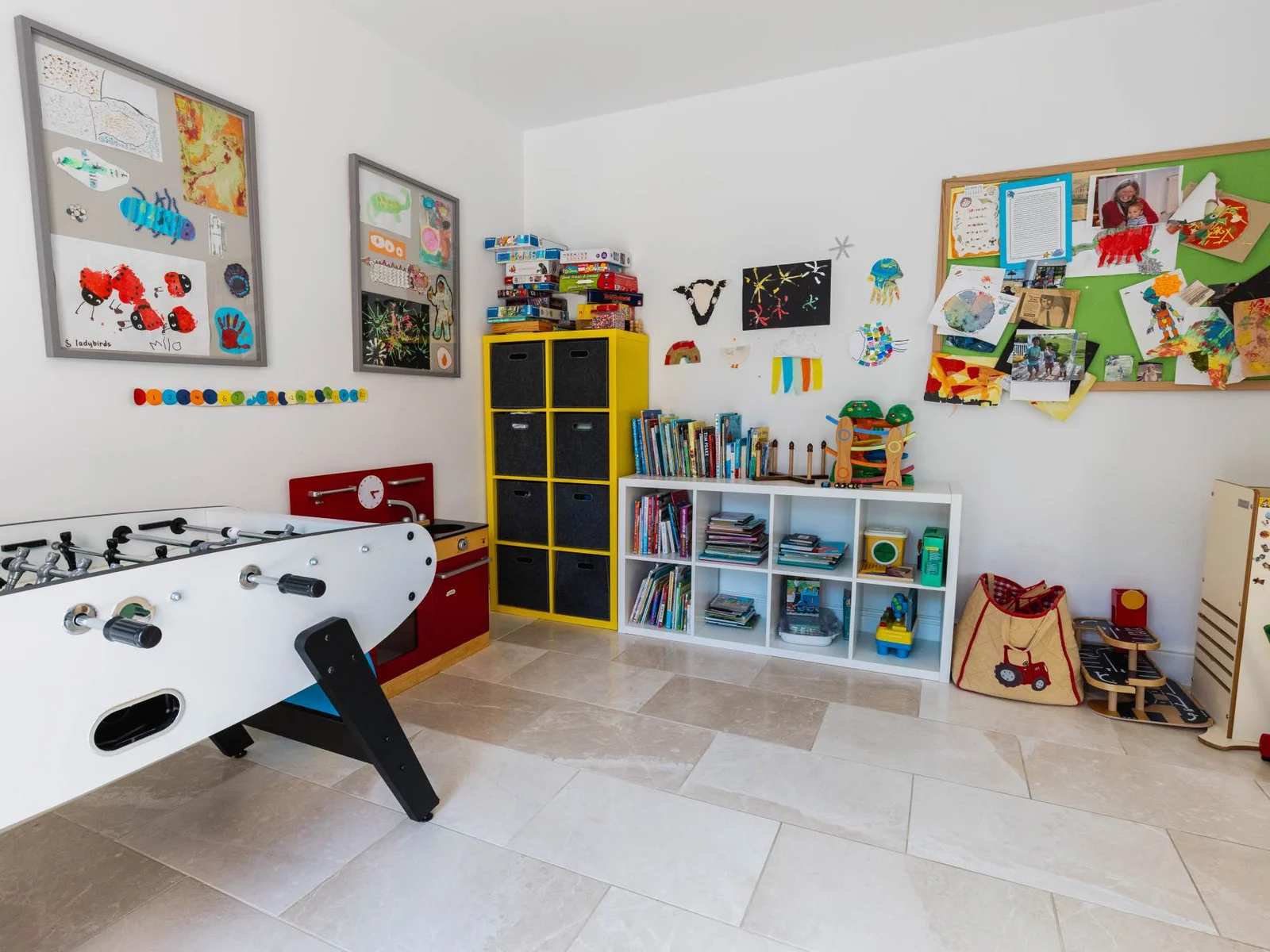 Spacious playroom with games, toys and organised storage, ideal for family stays and children’s activities.
