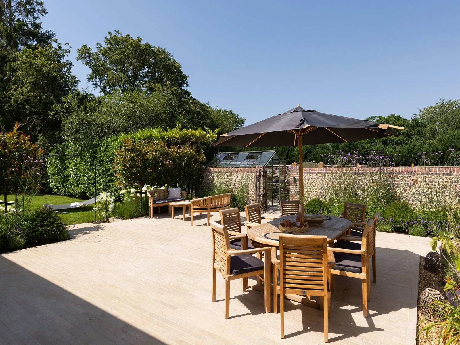 Outdoor dining area with parasol, perfect for leisurely meals in the sunshine