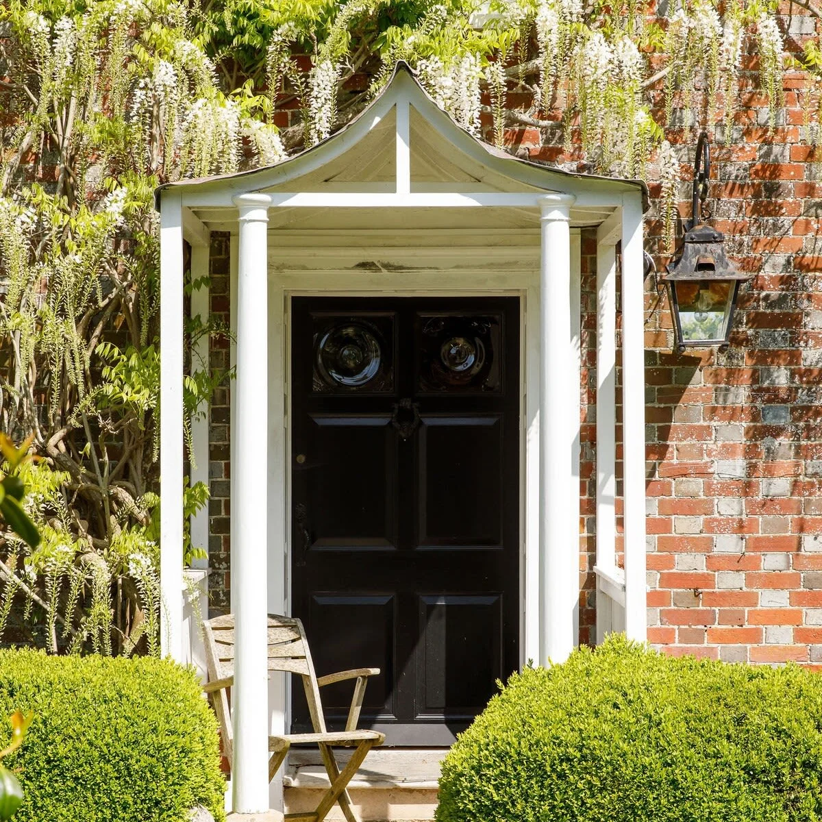 Stunning Wisteria covers the front of the main house.