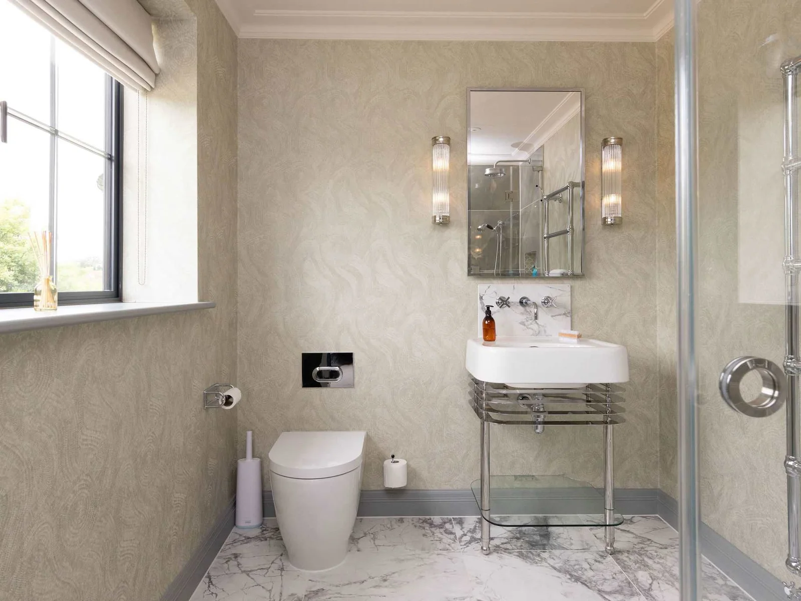 Beautiful bathroom with glass vanity and marble flooring