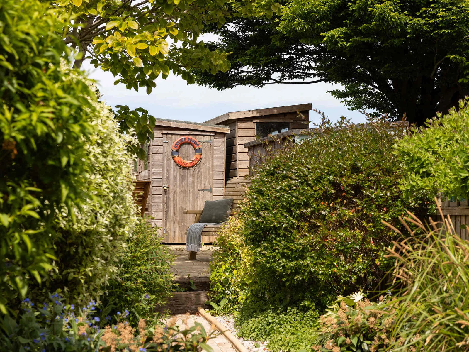 Head down the garden path to find a secluded, decked seating area.