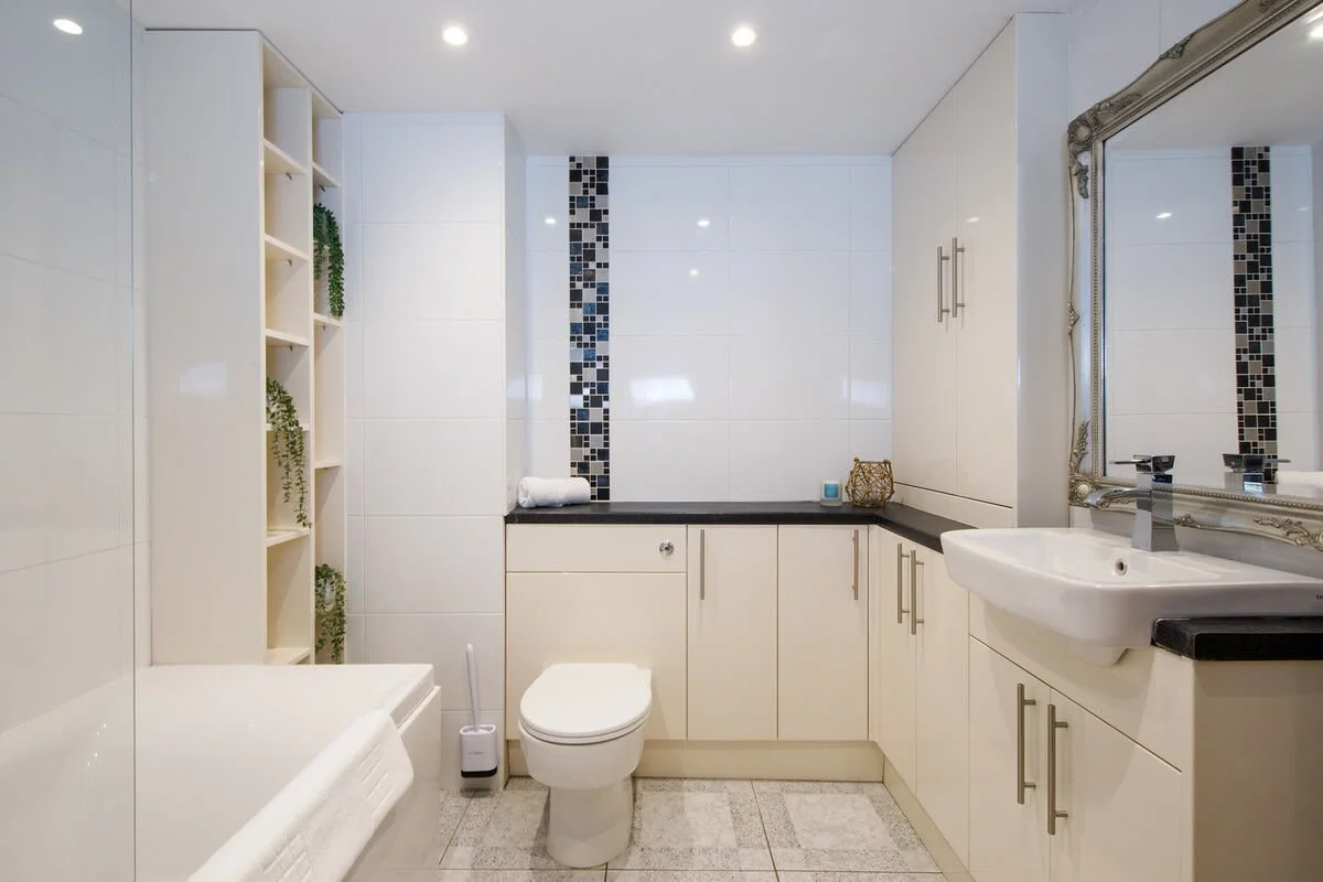 Bright bathroom with bath and shower.