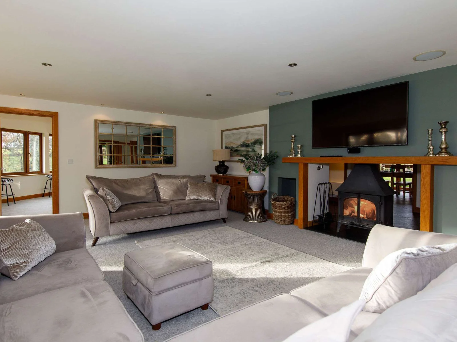 A spacious lounge with wood burner, large TV, river views and bifold doors onto the patio.