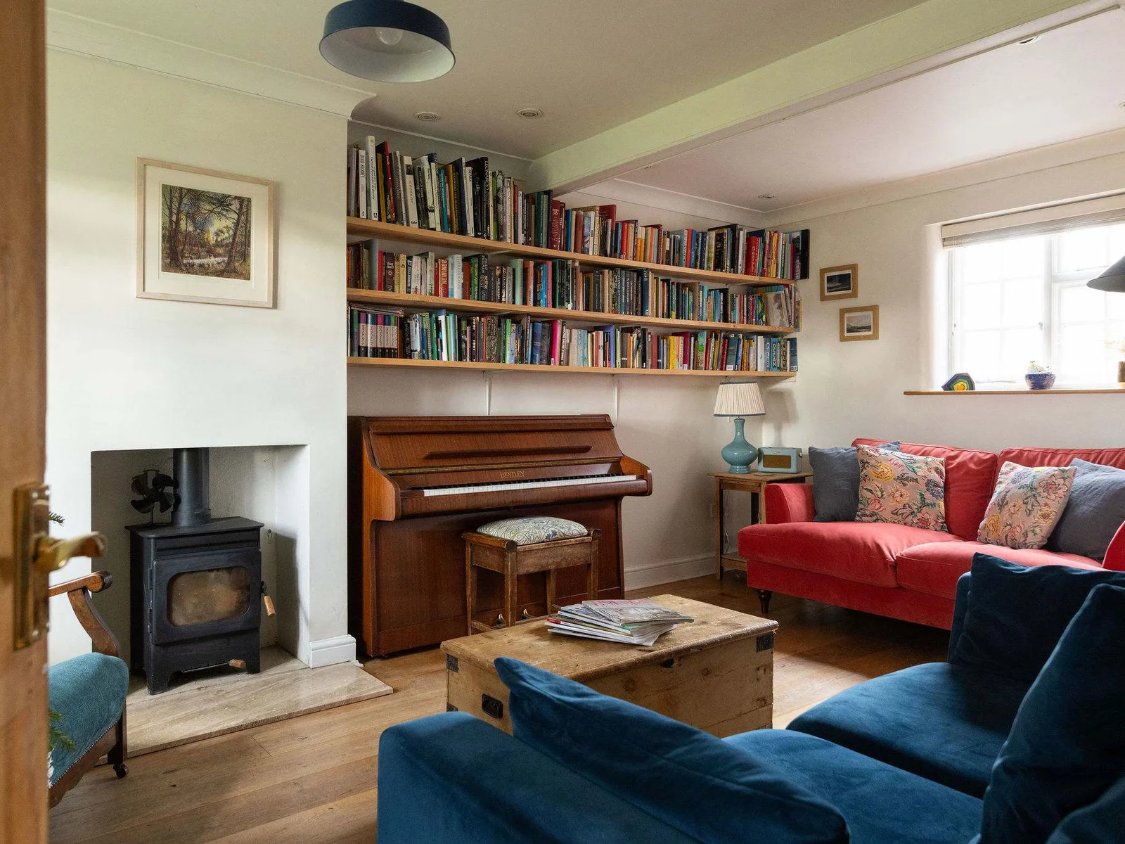 Welcoming lounge with wood-burning stove and piano