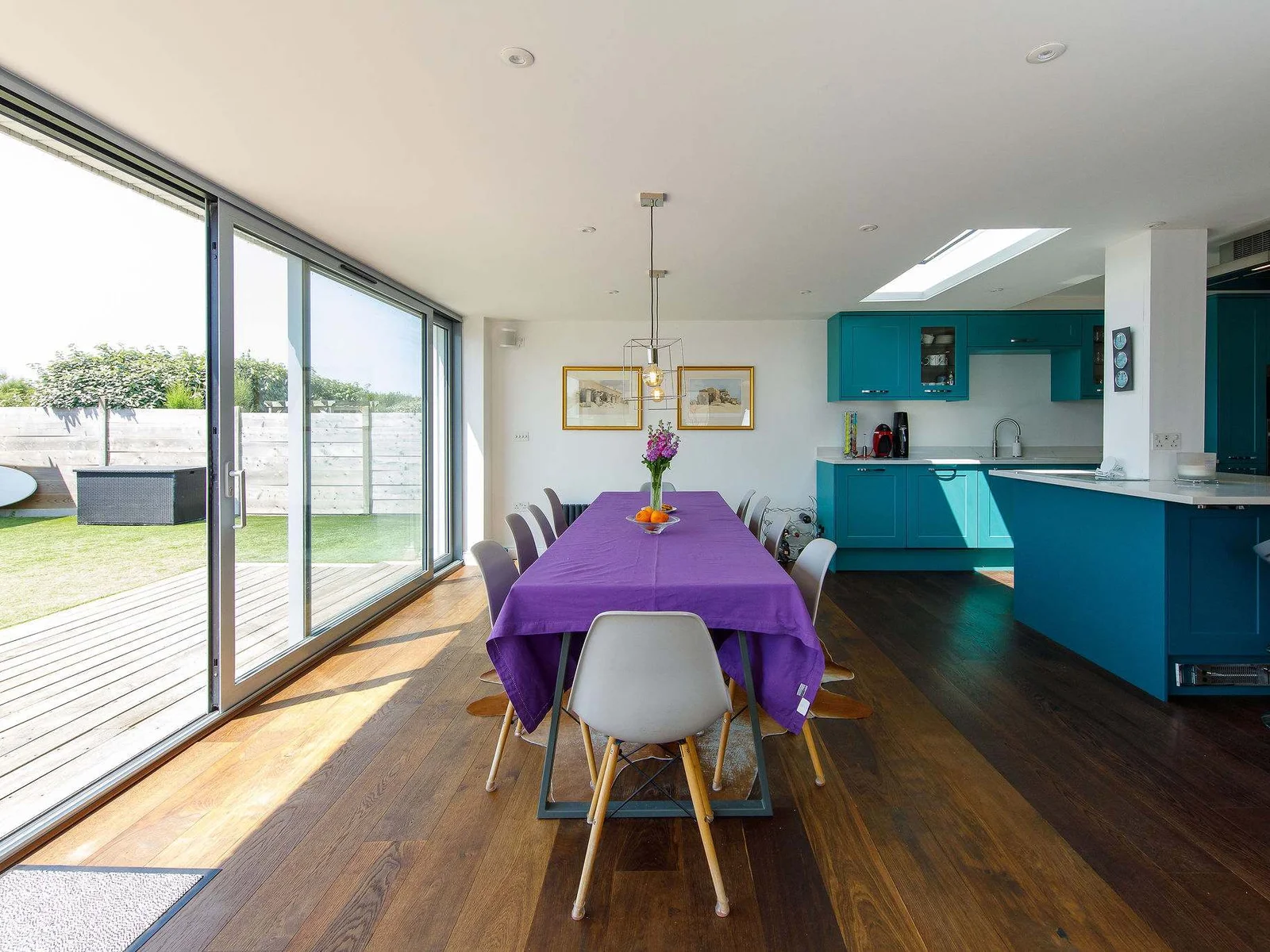 The main dining area sits between the kitchen and the patio. Open up the sliding doors on warmer days to enjoy the sea breeze while you eat.