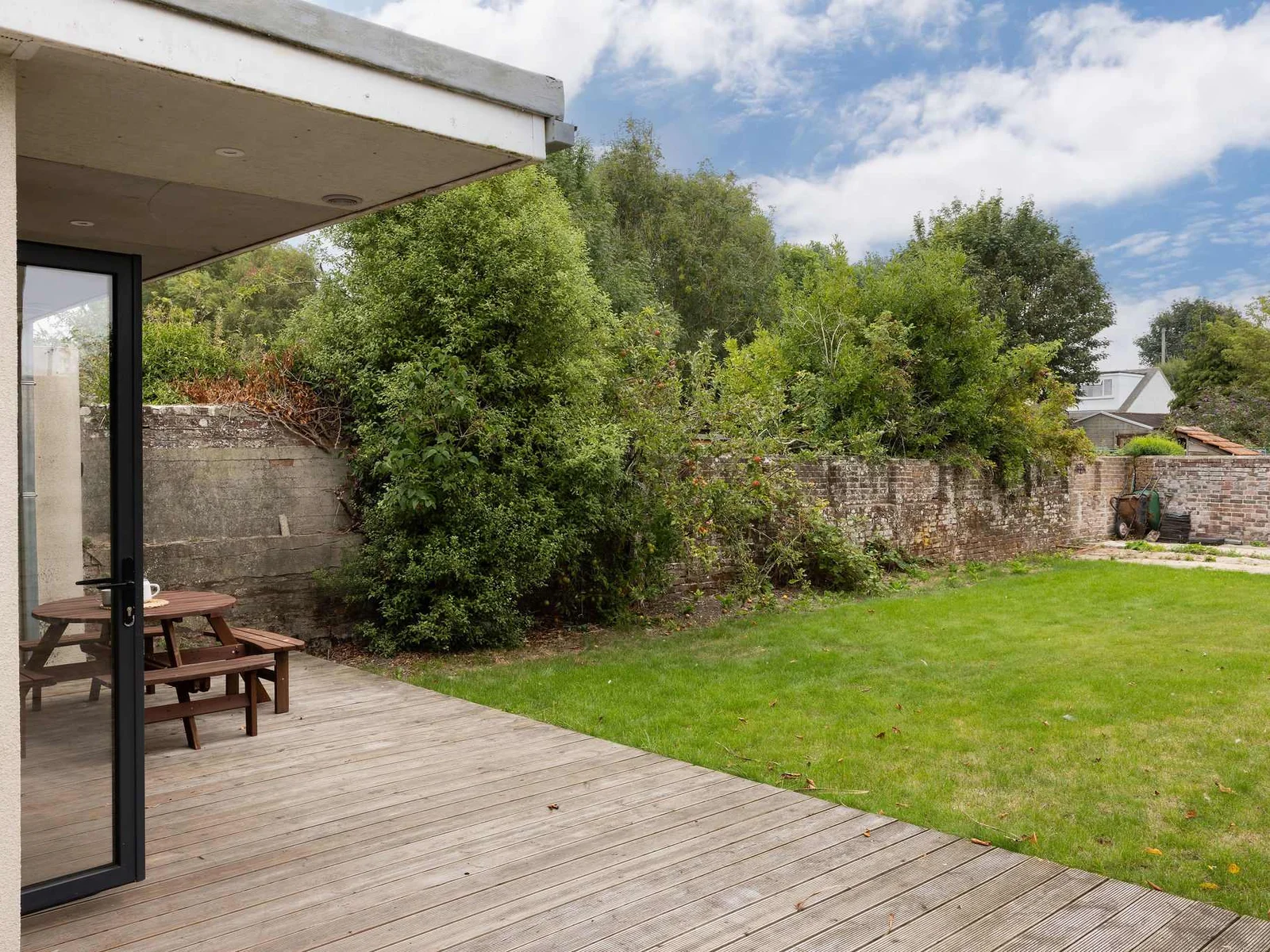 The rear garden has decking and grass to make use of!