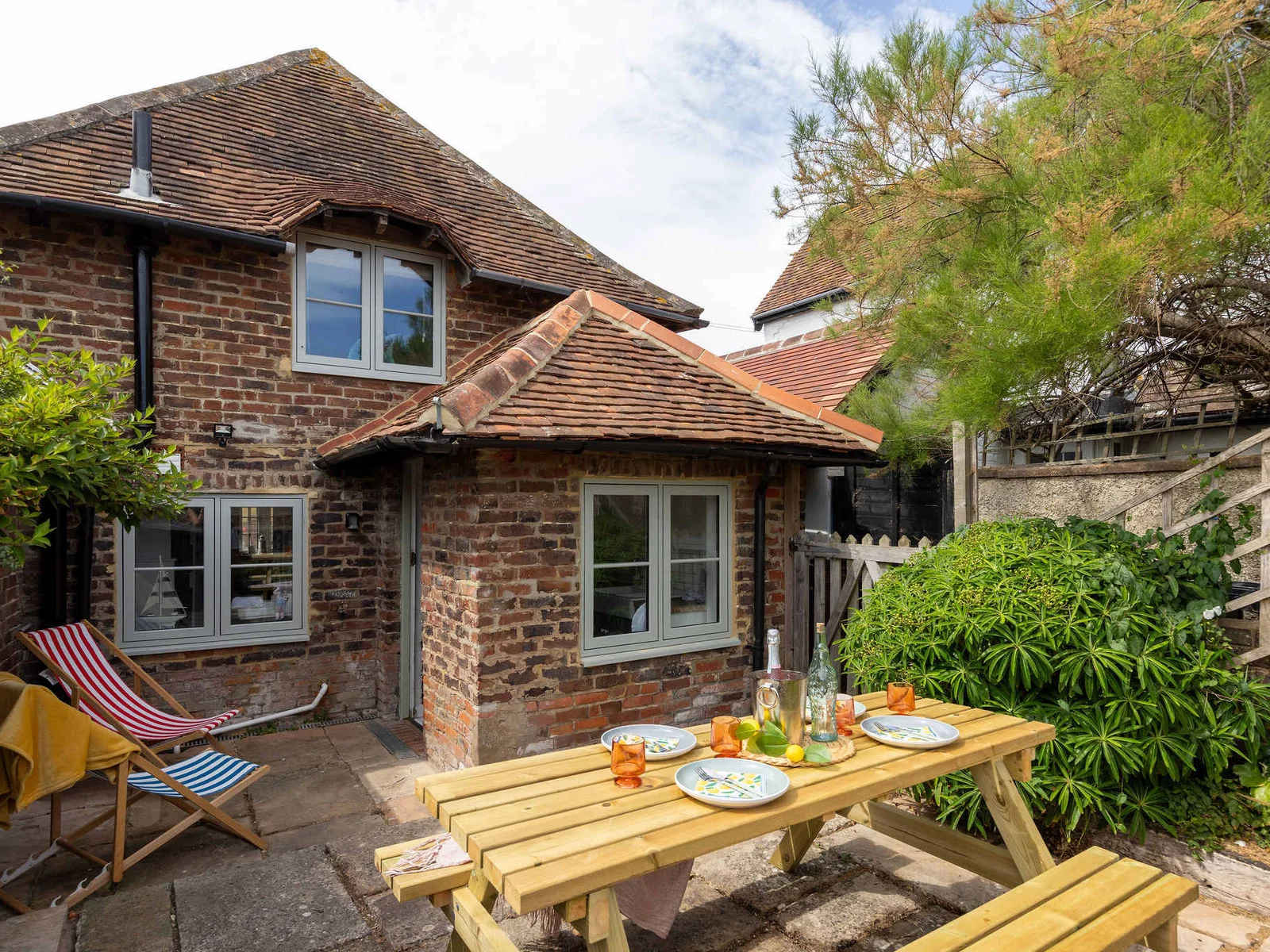 At the rear of the cottage, there’s a charming little patio!