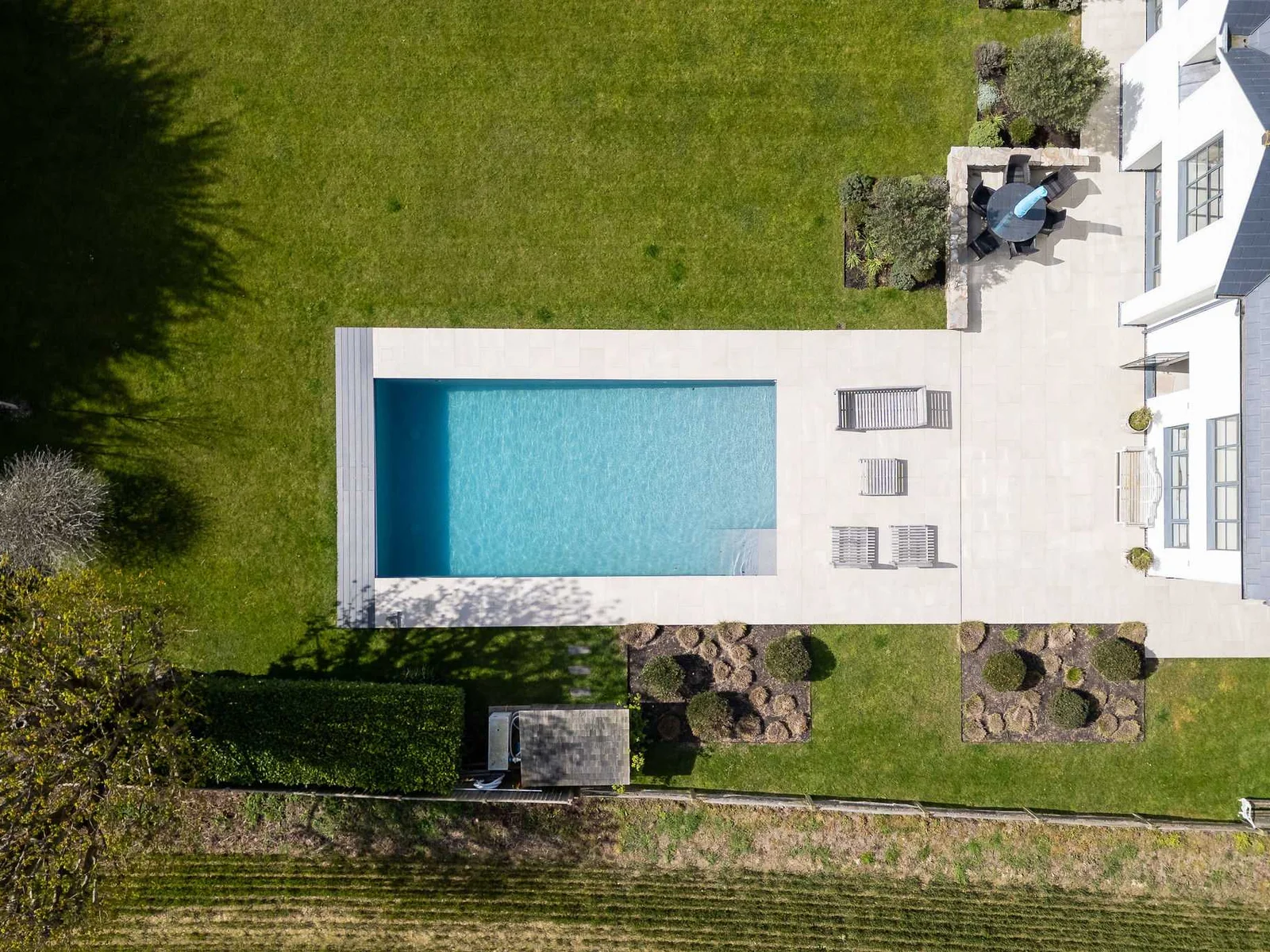 Bird's eye view of the heated pool nestled within beautifully landscaped gardens and mature planting.