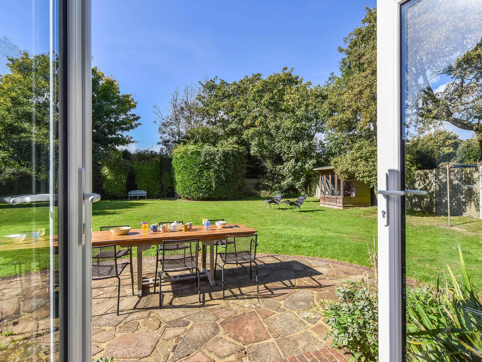 Kitchen doors open up onto the expansive lawn