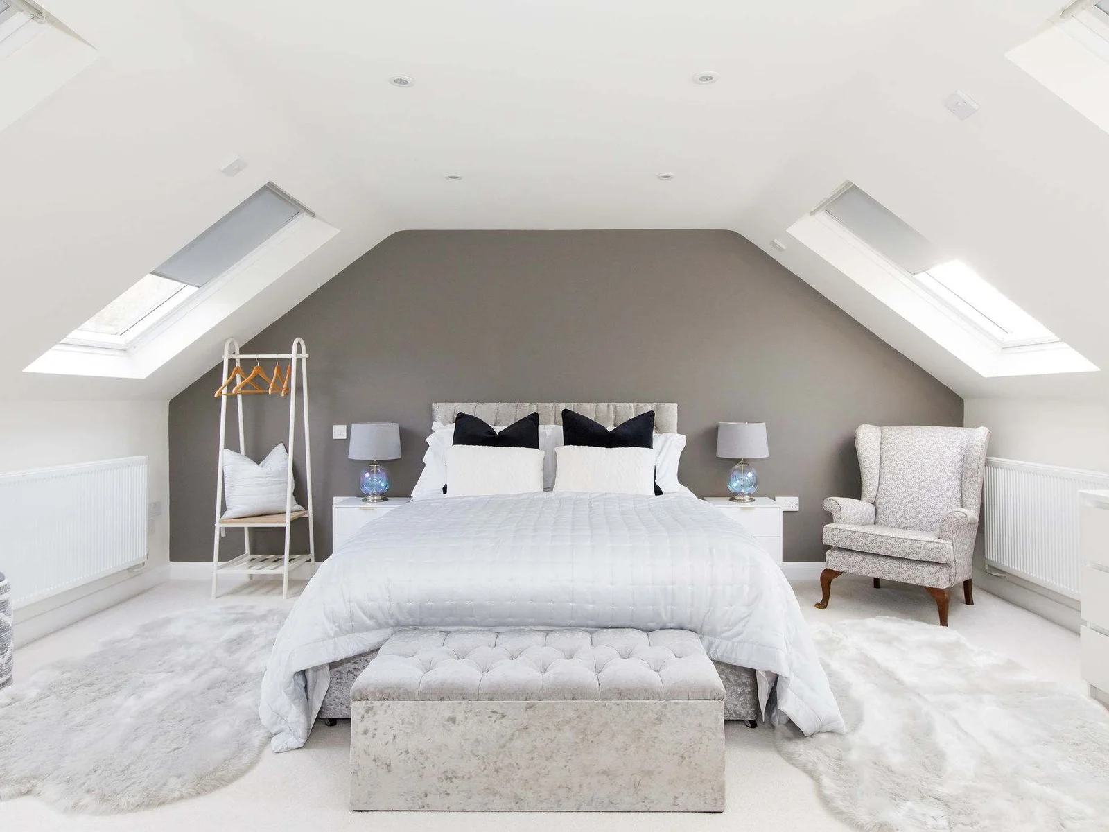 Discover a 6th bedroom with soft rugs underfoot and luxury pillows for sleepy heads.