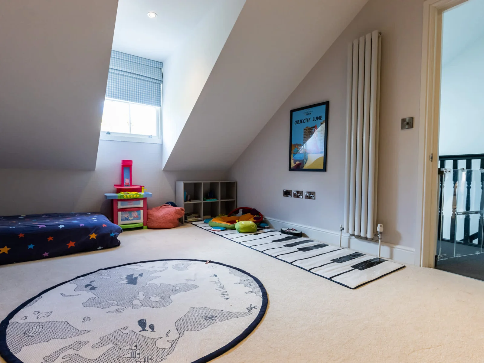 Loft play area with soft seating, toys and skylight—perfect for relaxing or keeping younger guests entertained.