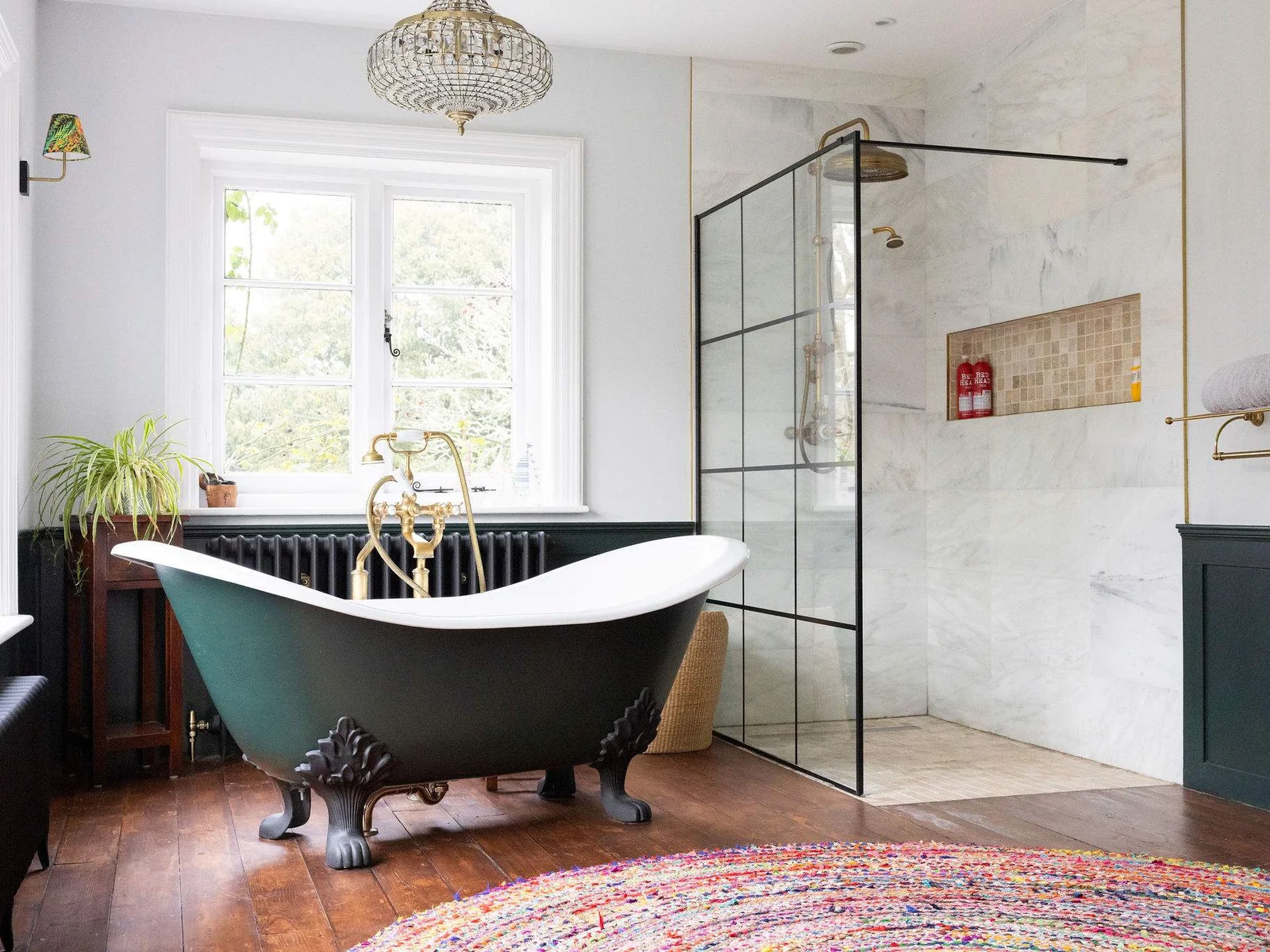 A spa-like en-suite with a roll-top bath and walk-in shower.