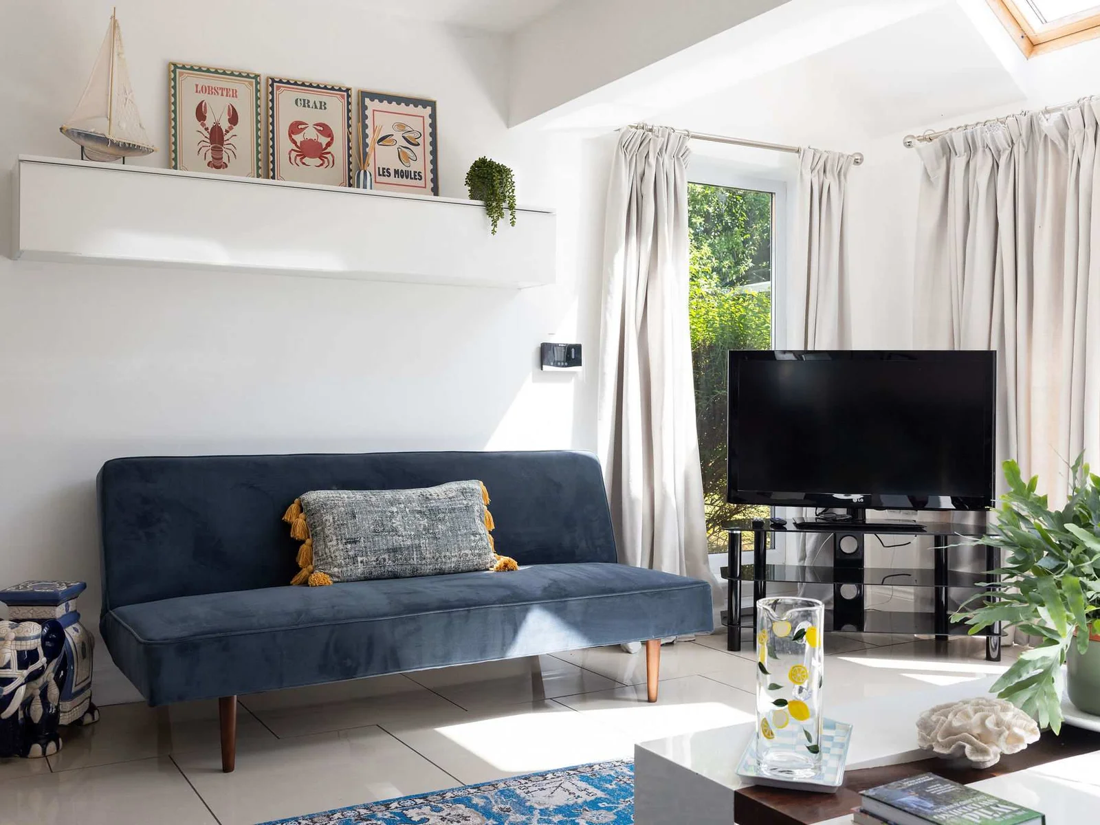 Relax on the comfortable sofa in this bright living space of our coastal retreat.