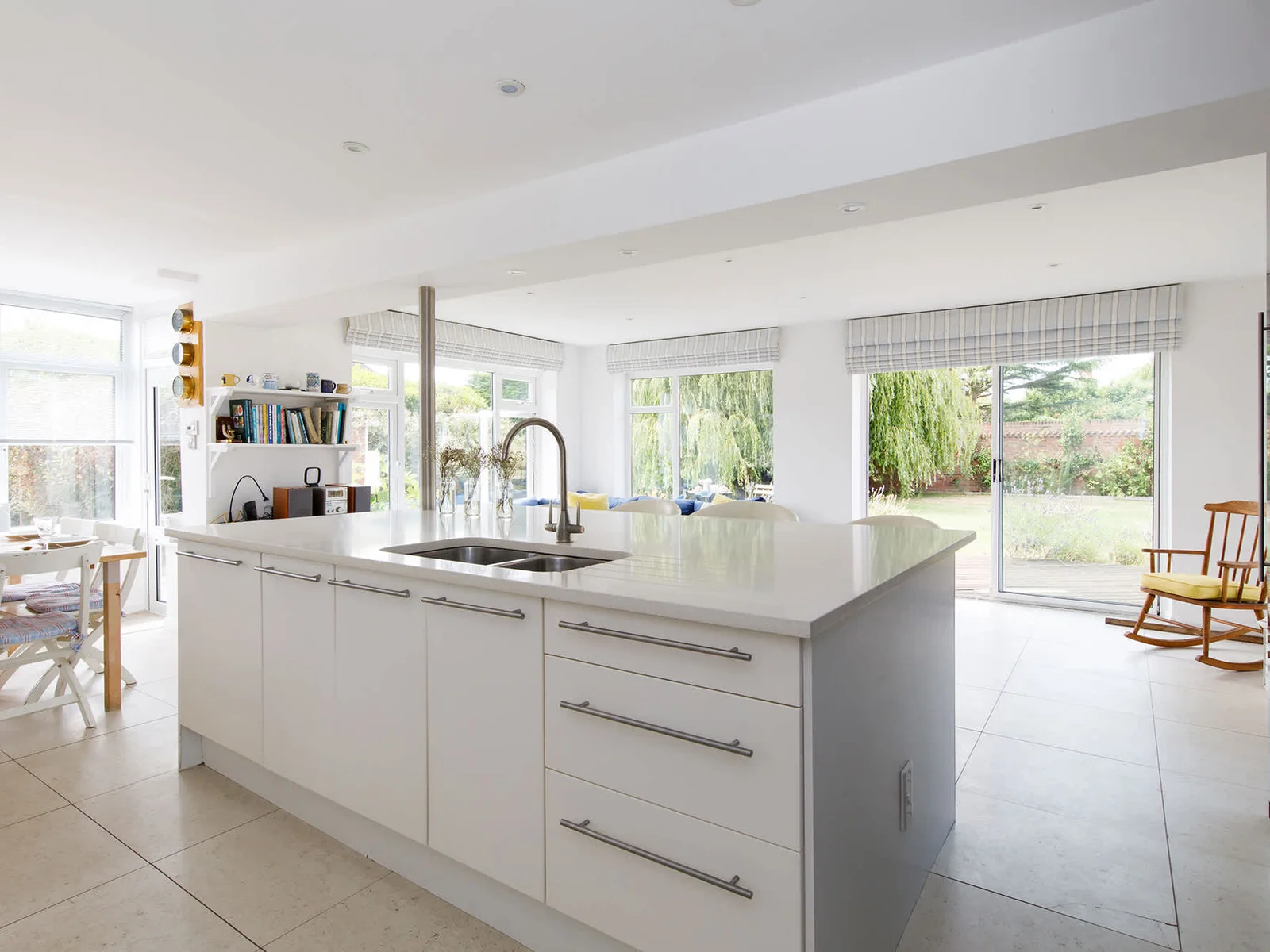 The open plan kitchen features a huge island complete with breakfast bar and four stools.
