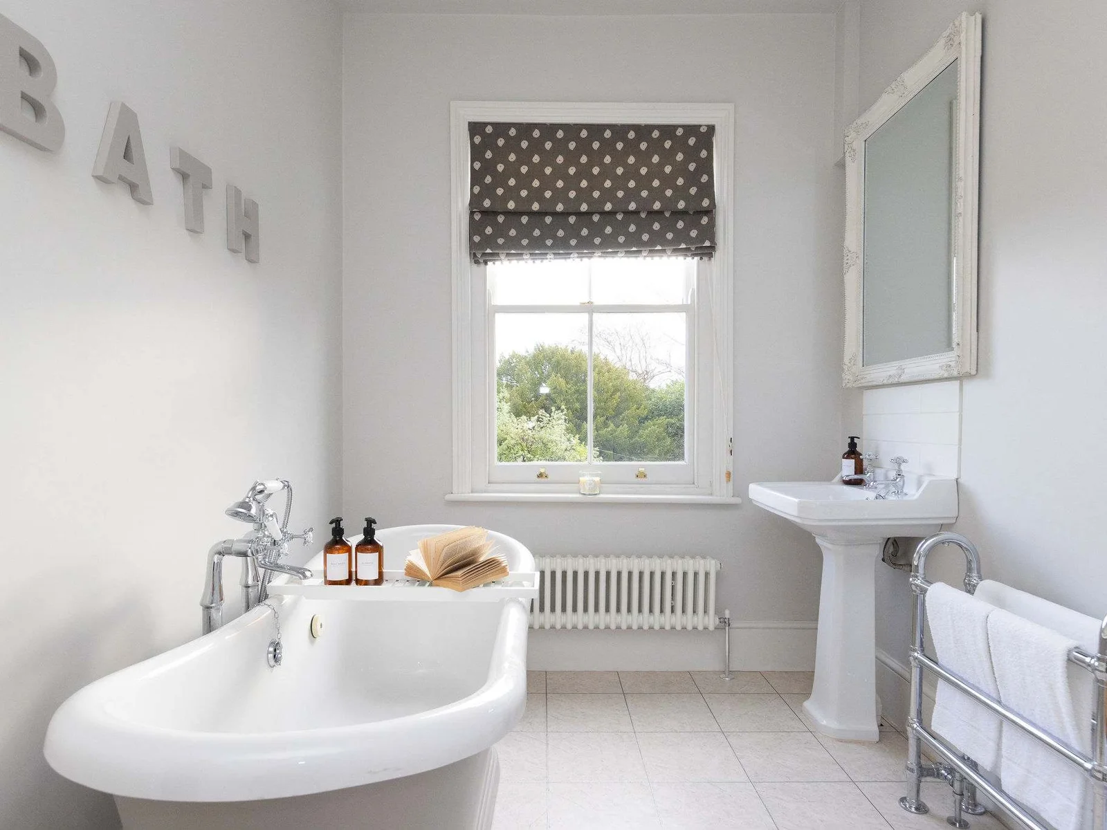 Bright bathroom with elegant freestanding bath and natural light.