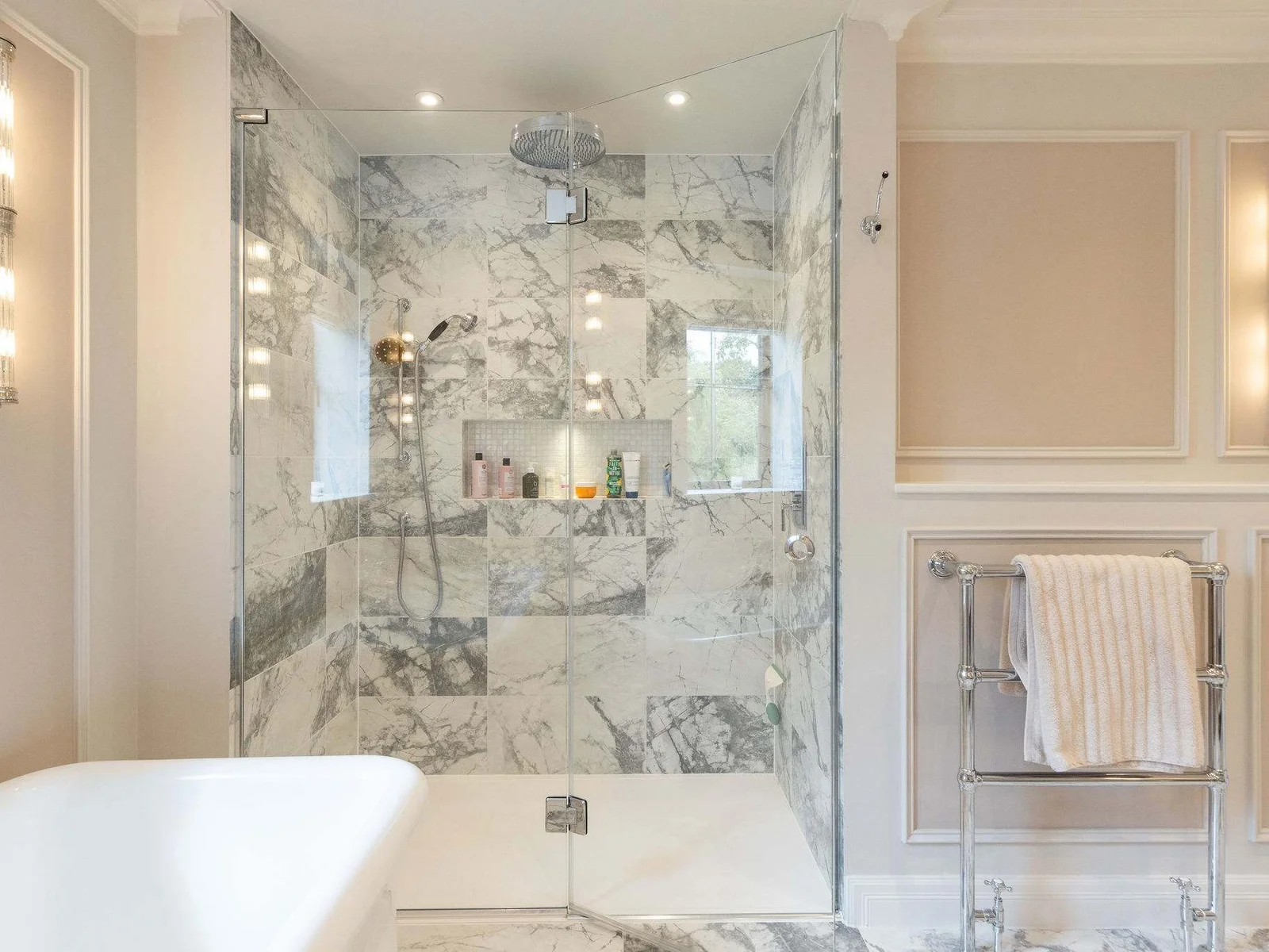Spacious rainfall shower with luxury marble finish and premium fittings