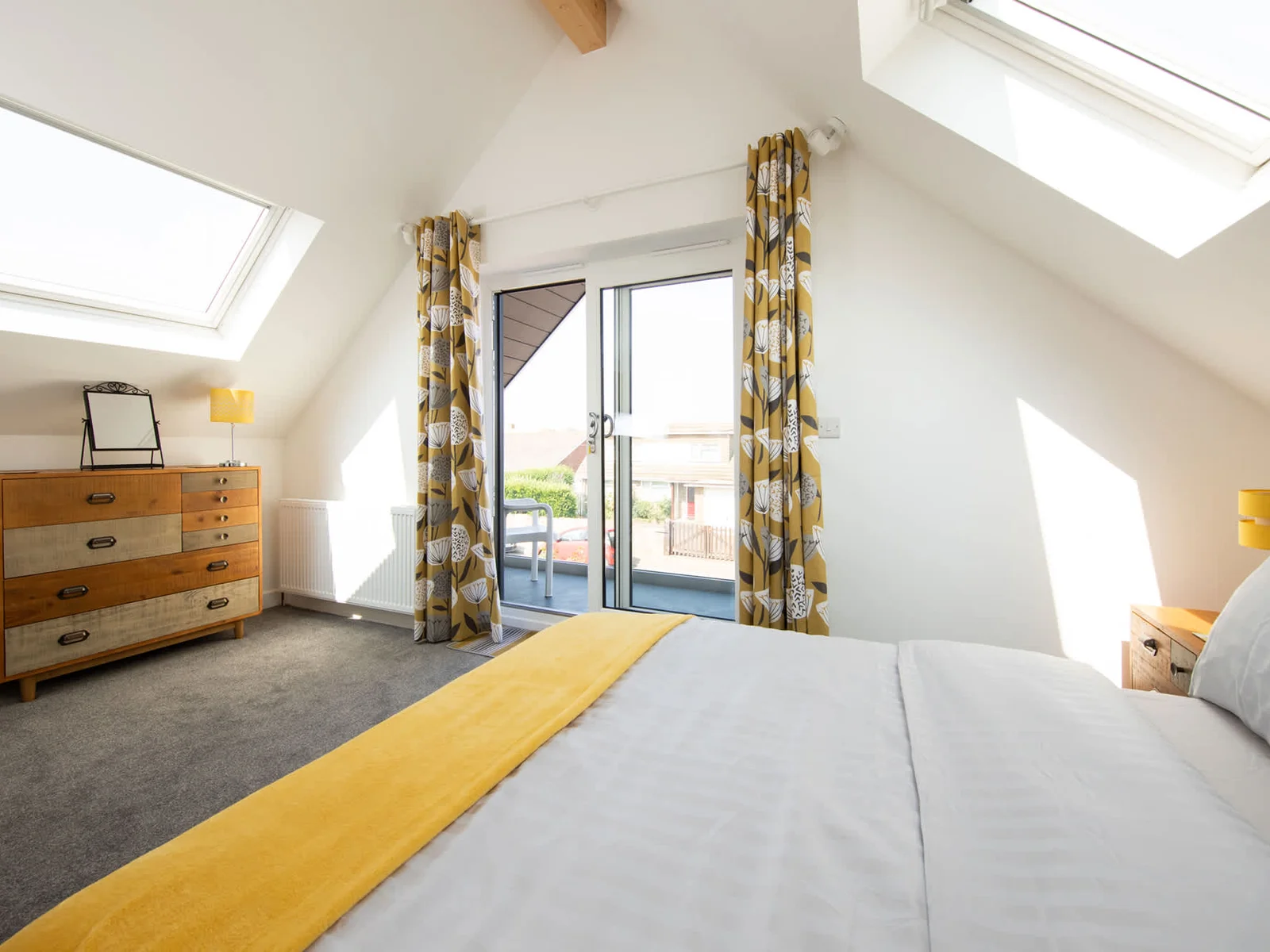 Another bright bedroom featuring its balcony!