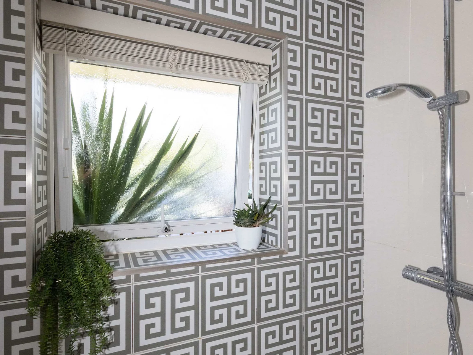 Patterned tiles add character to the walk-in shower