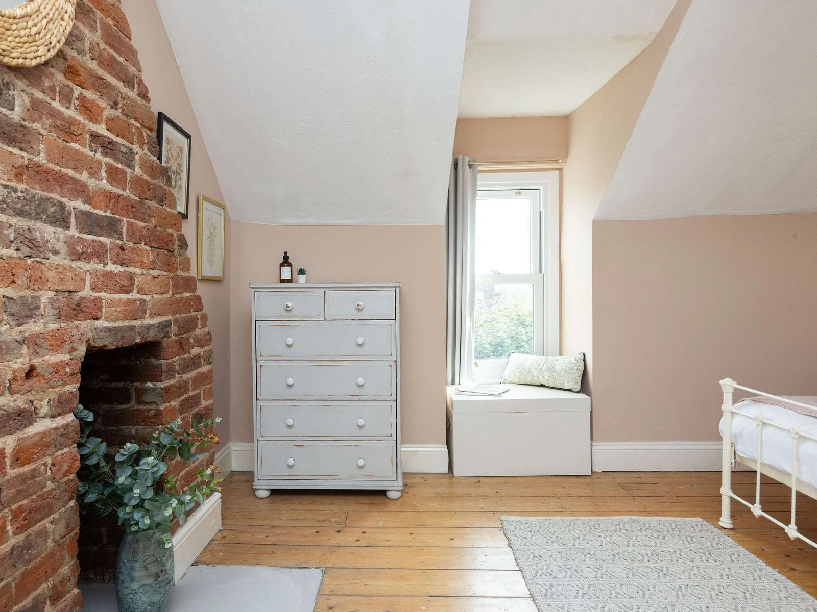 A cosy bedroom corner with a bright window seat.