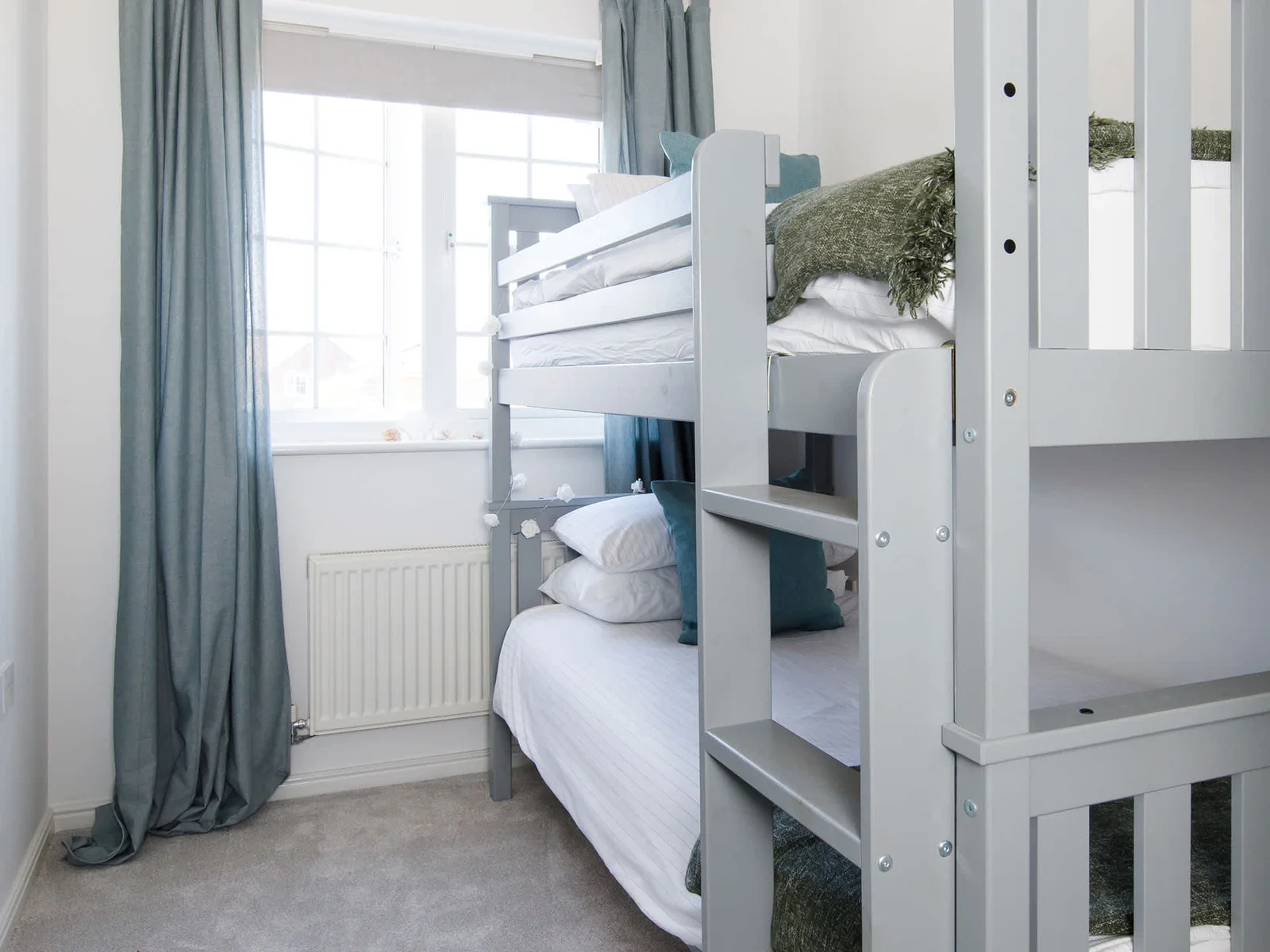 The bunk room has blinds and curtains to keep light out at night.