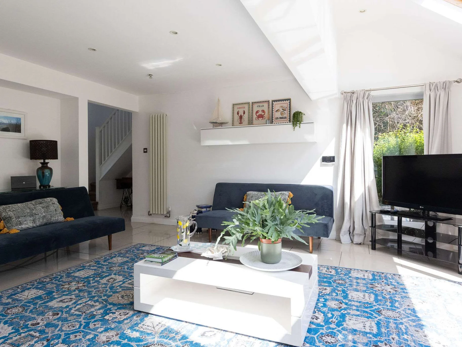 Relax in this beautiful holiday home living room, perfect for a modern coastal retreat.